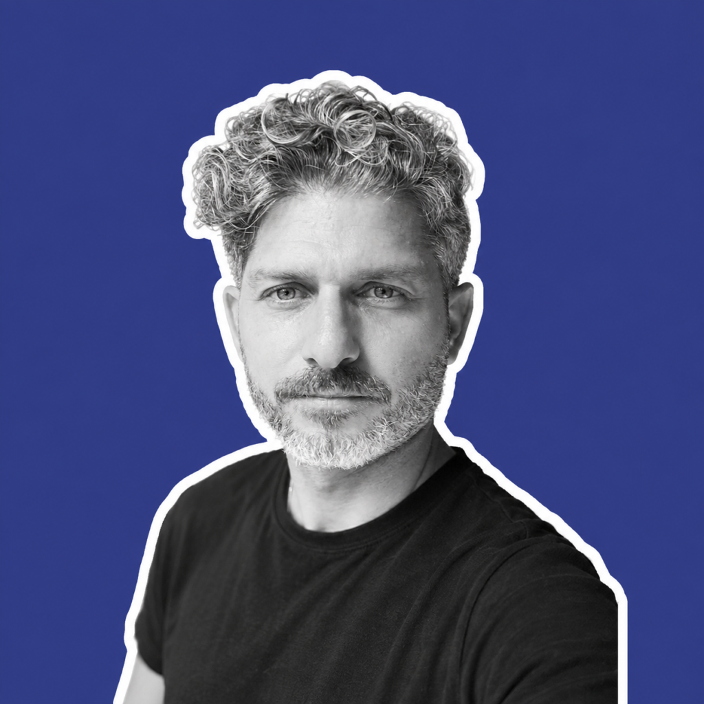 Black-and-white portrait of Yehuda Swed, founder and video producer at Arty-Shock in Berlin, against a blue background with a white cutout outline.